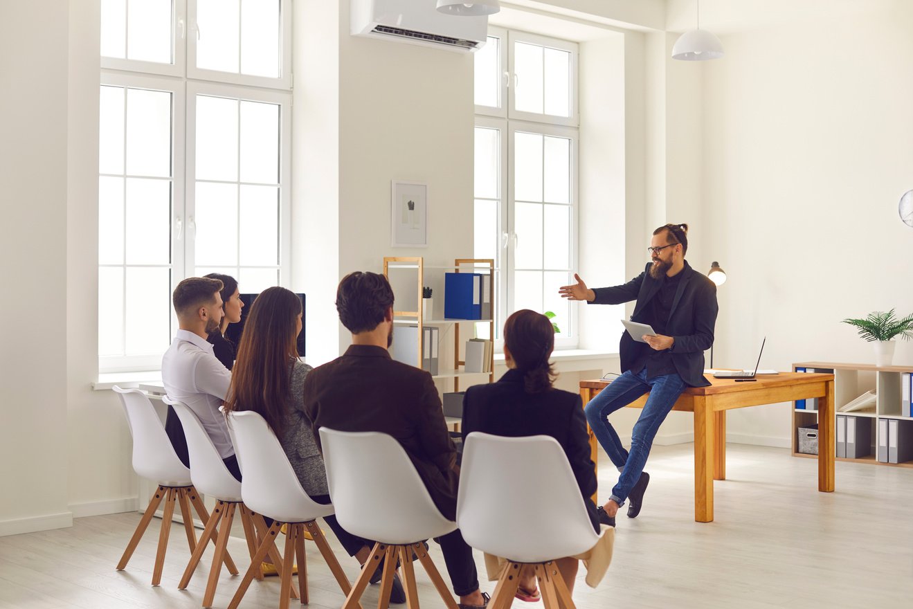 Businessman or Executive Manager Making Presentation or Training for Sitting Company Workers